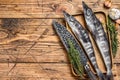 Raw mackerel icefish in a wooden tray. Wooden background. Top view. Copy space Royalty Free Stock Photo