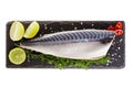 Raw mackerel with lemon and herbs on black slate cutboard