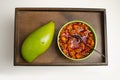 Raw Mango and Kairi and Mango Pickle Achar placed on a wooden Tray Royalty Free Stock Photo