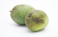 A raw mango beside a ripe mango isolated on white background Royalty Free Stock Photo