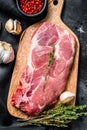 Raw marble pork steak on a wooden chopping Board. Organic meat. Black background. Top view Royalty Free Stock Photo