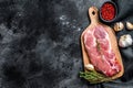 Raw marble pork steak on a wooden chopping Board. Organic meat. Black background. Top view. Copy space Royalty Free Stock Photo