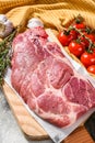 Raw marble pork steak on a wooden chopping Board. Organic meat. Gray background. Top view Royalty Free Stock Photo