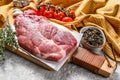 Raw marble pork steak on a wooden chopping Board. Organic meat. Gray background. Top view Royalty Free Stock Photo