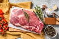 Raw marble pork steak on a wooden chopping Board. Organic meat. Gray background. Top view Royalty Free Stock Photo