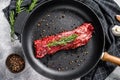 Raw marbled beef steak, fillet in a pan with ingredients for cooking. Gray background. Top view Royalty Free Stock Photo