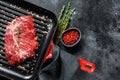 Raw marbled beef steak on a grill pan. Black background. Top view. Copy space Royalty Free Stock Photo