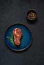 Raw marbled beef steak on plate ready to cook with microgreens. Royalty Free Stock Photo