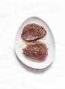 Raw marinated beef steak on a light background, top view Royalty Free Stock Photo