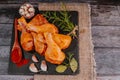 Raw marinated chicken drumsticks sprinkled with spice, chili pepper pieces, bay leaves prepared to cook in a dish, view from above Royalty Free Stock Photo