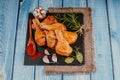 Raw marinated chicken drumsticks sprinkled with spice, chili pepper pieces, bay leaves prepared to cook in a dish, view from above Royalty Free Stock Photo