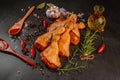 Raw marinated chicken drumsticks sprinkled with spice, chili pepper pieces, bay leaves prepared to cook in a dish, view from above Royalty Free Stock Photo