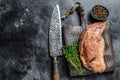 Raw marinated in mustard beef tri-tip steak for bbq. Black background. Top view. Copy space Royalty Free Stock Photo