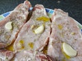 Raw and marinated pork loins - rosamary, garlic, oil and lemon juice