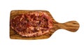 Raw marinated pork steak with red pepper flakes, on cutting board made from olive wood. Isolated on white background, top view