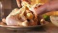 Raw marinated whole chicken for baking in the oven. Action. Close up of woman hand putting white cream sauce with Royalty Free Stock Photo