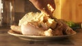 Raw marinated whole chicken for baking in the oven. Action. Close up of woman hand putting white cream sauce with Royalty Free Stock Photo