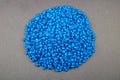Raw material plastic granules light blue cyan, close-up raw material brown background!