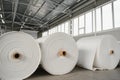 Raw materials warehouse. Many large coils of finished propylene hose made of woven thread for making industrial bags.