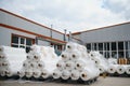 Raw materials warehouse. Many large coils of finished propylene hose made of woven thread for making industrial bags.