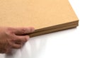 Raw MDF boards that are placed by hand on a white background. Royalty Free Stock Photo