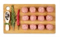 Raw meat balls on a chopping board. Chili pepper, rosemary, spices Royalty Free Stock Photo