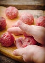 Raw meat balls on a chopping board. Royalty Free Stock Photo