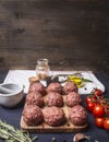 Raw meat balls vegetables, butter and herbs on wooden rustic background top view close up border,with text area Royalty Free Stock Photo