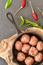 Raw meat balls vintage cast-iron pan Royalty Free Stock Photo