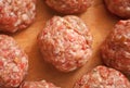 Raw meat balls on the wooden cutboard. Top view