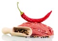 Raw meat beef, red and black pepper isolated on white. Royalty Free Stock Photo