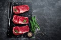 Raw meat, beef steak on black background