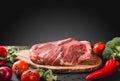 Raw meat, beef steak on cutting board with knife on black background Royalty Free Stock Photo