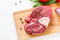 Raw meat beef steak with fresh vegetable on wooden cutting board. Top view Royalty Free Stock Photo