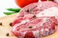 Raw meat beef steak and vegetable on wooden cutting board. Close-up. Royalty Free Stock Photo