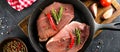 Raw meat in black cast-iron pan. Food banner. Top view, close-up Royalty Free Stock Photo