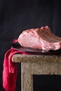 Raw meat on black plate and red towel. Clasic still life