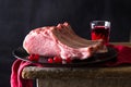 Raw meat on black plate and red towel. Clasic still life