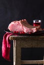 Raw meat on black plate and red towel. Clasic still life