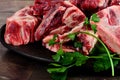 Raw meat with bone on clay plate and brown stone background.Raw meat with beef bone