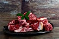 Raw meat with bone on clay plate and brown stone background.Raw meat with beef bone Royalty Free Stock Photo