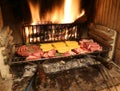 Raw meat cooking in the fireplace with a warm fire lit
