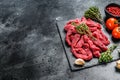 Raw meat cut into thin strips for beef Stroganoff. Black background. Top view. Copy space Royalty Free Stock Photo