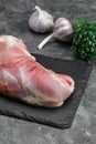 raw meat on a cutting board with spices on a stone background