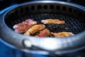 Raw meat grilling in grating firewood oven in asian restaurant,side view Royalty Free Stock Photo