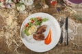 Raw meat with herbs, seasonings, tomato cherry, cucumbers and white souce cream on wooden round table. Row beef steak grill pan st Royalty Free Stock Photo