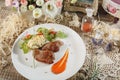 Raw meat with herbs, seasonings, tomato cherry, cucumbers and white souce cream on wooden round table. Row beef steak grill pan st Royalty Free Stock Photo