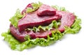 Raw meat on lettuce leaves. Royalty Free Stock Photo