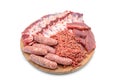 Raw meat products. pork ribs, neck steaks, homemade sausages, minced meat garnished with spices, on a round wooden chopping board. Royalty Free Stock Photo