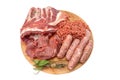 Raw meat products.Shish Kebab of pork ribs, steaks, fried sausages, minced meat, decorated with spices, on a round wooden cutting Royalty Free Stock Photo
